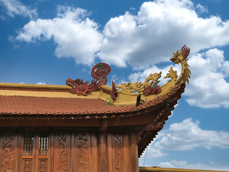 Detailed Vietnamese temple roof with dragons - Close-up of a traditional Vietnamese temple roof with...