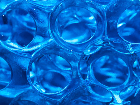 Abstract Blue Balls Water Texture Pattern - Close-up macro shot of transparent blue spheres, creating a fascinating liquid or futuristic texture. Ideal for backgrounds and abstract design.の写真素材