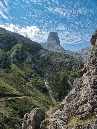 Picu Urriellu Hiking Trail in Picos de Europa National Park - Dramatic view of Naranjo de Bulnes from the challenging trail in Asturias, Spain, on a sunny day with altocumulus clouds.の写真素材