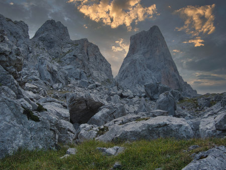 Imposing limestone peak at sunrise or sunset - Majestic, vertical limestone wall in a national park, Spain, under a dramatic blue sky.の写真素材
