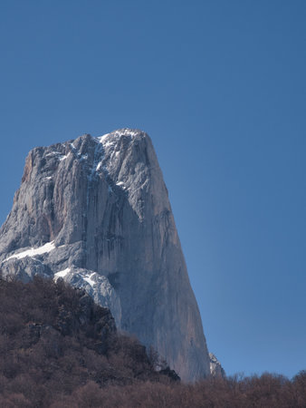 Majestic rock monolith against blue sky - Close-up shot of the stunning Pico Urriellu (Naranjo de Bulnes) in Picos de Europa National Park, Spain, on a bright, sunny day.の写真素材