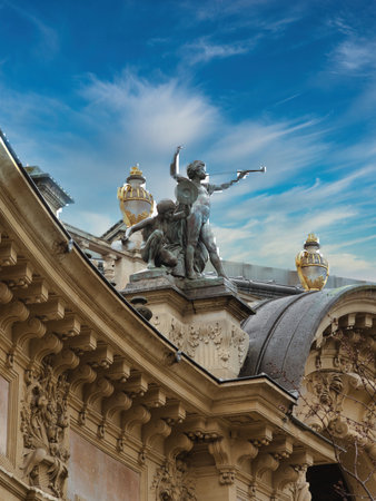 Golden Statue on Parisian Palace Dome - Close-up architectural shot of an ornate dome and a majestic golden statue against a vibrant blue sky in Paris.の写真素材