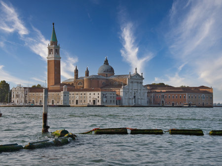 San Giorgio Maggiore Island and Blue Sky - Iconic view of the San Giorgio Maggiore island with its prominent Campanile and church, seen across the Venetian Lagoon under a vibrant blue, cloudy sky.の写真素材