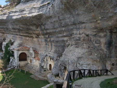 San BernabÃ© Hermitage in Ojo GuareÃ±a - Historic Hermitage of San BernabÃ© built into the massive limestone rock face and cave entrance of the Ojo GuareÃ±a complex in Burgos, Spain.の写真素材