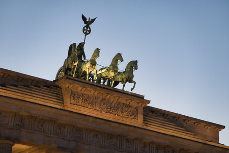 Brandenburg Gate illuminated at twilight - The iconic Brandenburg Gate in Berlin, a symbol of peace and unity, beautifully illuminated against the twilight sky at Pariser Platz, Germany.の写真素材