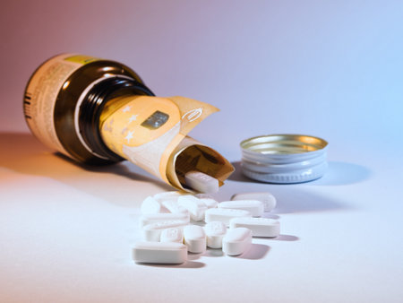 Fifty Euro bill inside a medicine bottle with yellow pills scattered, illustrating the financial burden and high prices of pharmaceuticals and medical expenses.の写真素材