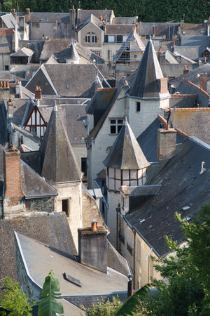 Loire Valley Old Town Rooftop Scene - Elevated view looking down over a charming historic French town, showcasing a dense array of traditional slate and tile roofs in the Loire Valley.の写真素材