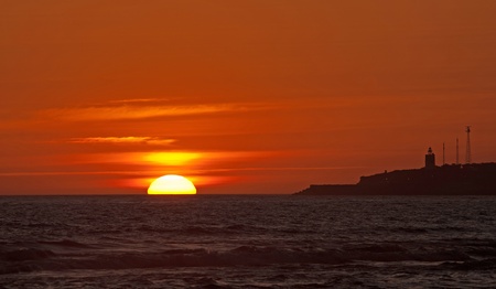 Sea and lighthouse at sunset, Spainの写真素材