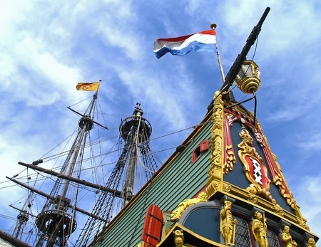 Flags waving above an ancient tall shipの写真素材