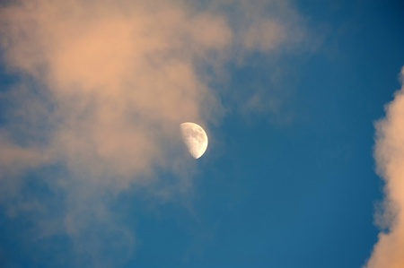 The moon in a blue and cloudy skyの写真素材