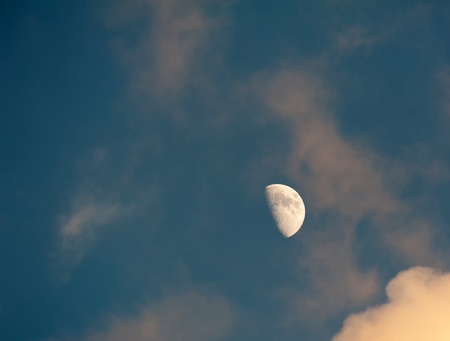 The moon in a blue and cloudy skyの写真素材