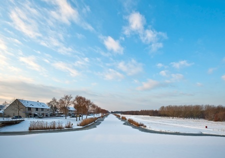 Frozen canal in a residential areaの写真素材
