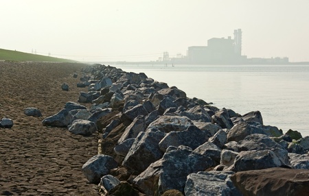 Power plant in the haze along a damの写真素材