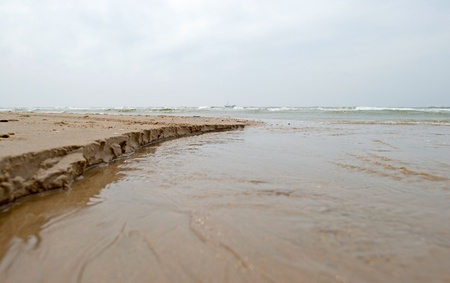 Water running into the seaの写真素材