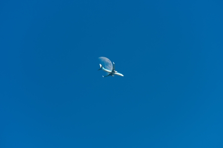 Airliner flying along the moon