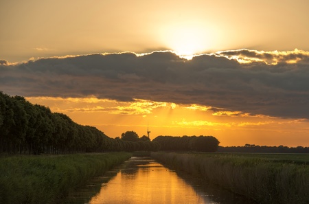 Dawn over a canal in springの写真素材