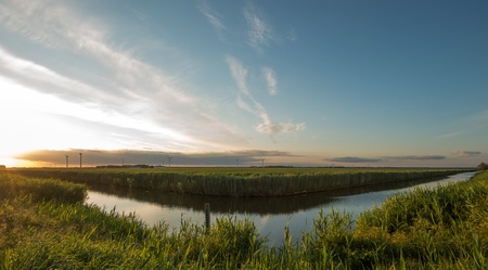 Dawn over a canal in springの写真素材