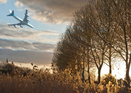 Plane flying into the sunset