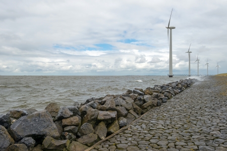 Wind turbines in a lake along a dikeの写真素材