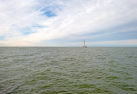 Sailboat sailing on a lake at fallの写真素材