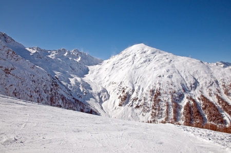 Mountain in winter under a blue skyの写真素材