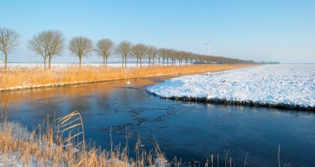 Canal through the countryside in winterの写真素材