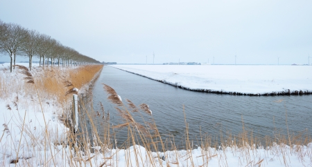 Canal through a snowy countrysideの写真素材