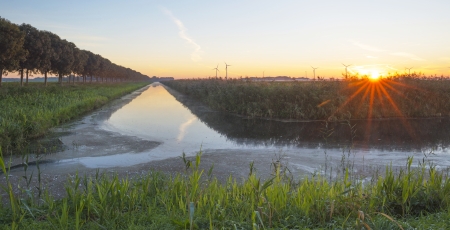 Canal through the countryside at dawn の写真素材
