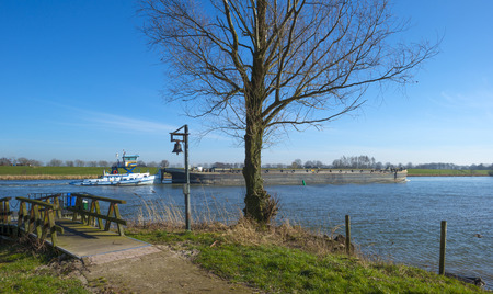 Barge sailing on a sunny river in winterの写真素材
