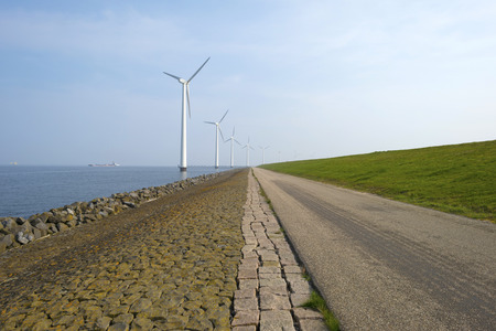 Wind turbines in a lake along a dike