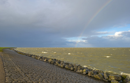 Rainbow over the horizon of a sea