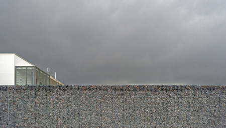 Wall of steel and stones in winterの写真素材