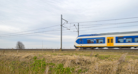 Train moving through the countryside in winterの写真素材