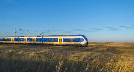 Train moving through the countryside in winterの写真素材