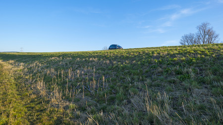 Car parked along a dike in winterの写真素材