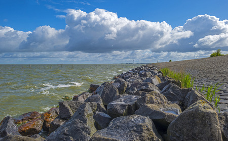 Deteriorating weather on a dike along a sea in spring