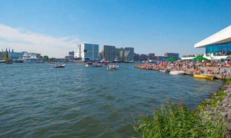 Ships sailing or mooring in the harbor of Amsterdamのeditorial素材
