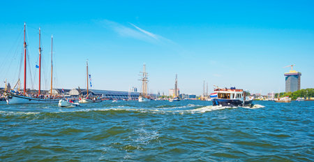 Ships sailing or mooring in the harbor of Amsterdamのeditorial素材