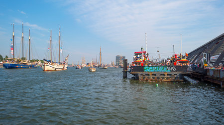 Ships sailing or mooring in the harbor of Amsterdamのeditorial素材