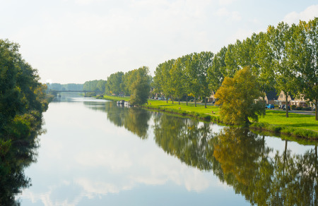 Trees along a canal through a residential areaの写真素材