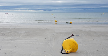 Buoy on a beach along a sea in summer