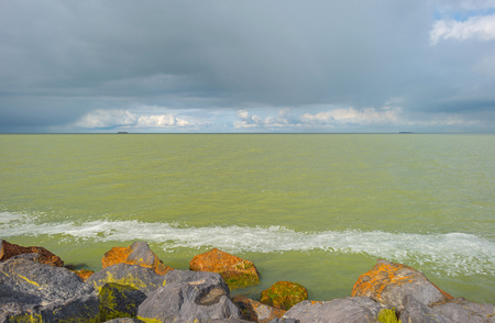 Dike along a lake in winterの写真素材