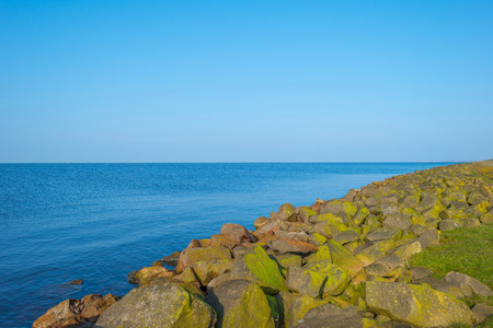 Dike along a lake in winterの写真素材