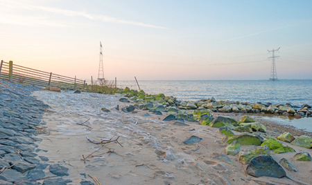 Beach along a lake in winter at sunrise