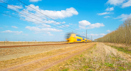 Electric train speeding through natureの写真素材