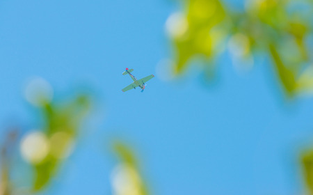 Plane flying in a blue sky in spring