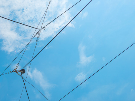 Overhead lines for electric trams in a blue sky
