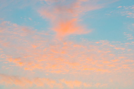 Clouds in a blue sky at sunrise