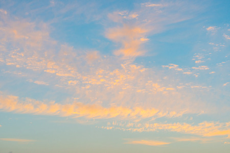 Clouds in a blue sky at sunrise