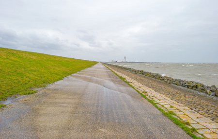 Dike along a stormy lake in winter